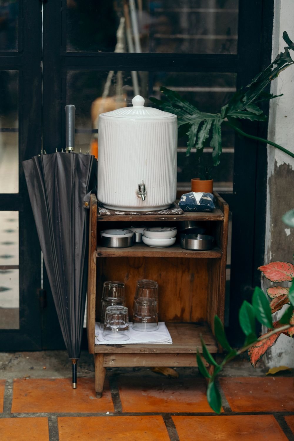 Water dispenser with glasses in a home kitchen