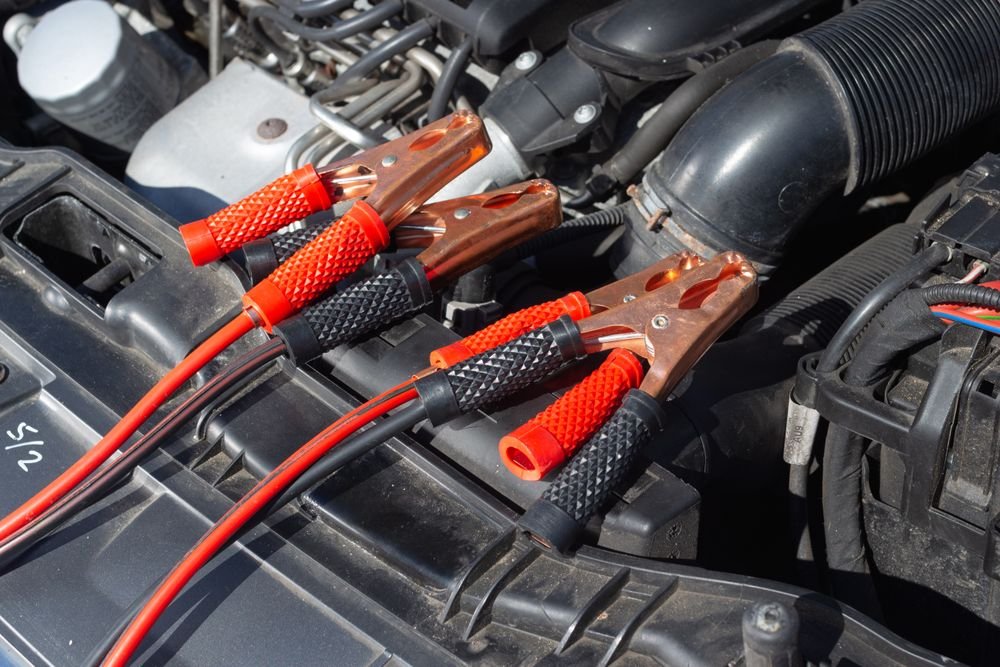 Close-up of jump starter cables connected to a car battery